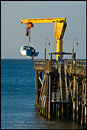 Picture: Launching a small motor boat from pier at Gaviota Beach State Park, near Santa Barbara, California 
