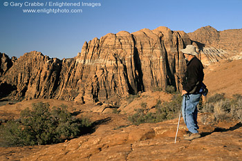 Image: Hiker overlooking red sandstone cliffs at Snow Canyon State Park, near St. George, Utah's Dixie, Utah